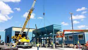 Crane lifting large sifter