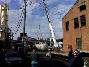 Crane lifting large tank