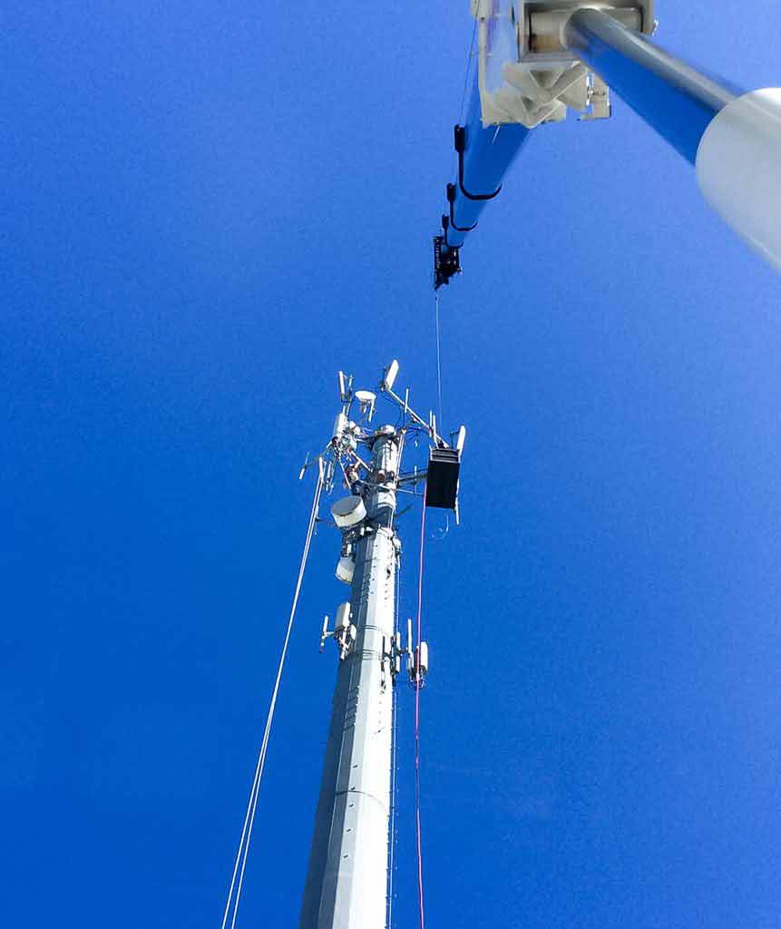 Crane placing cell tower