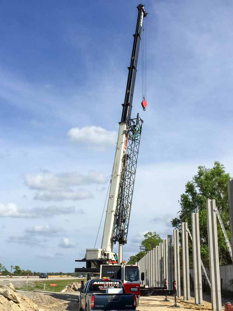 Crane placing concrete pillars